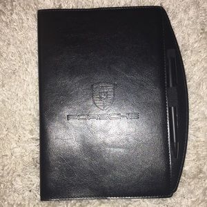 Black branded leather Porsche notebook with pen.